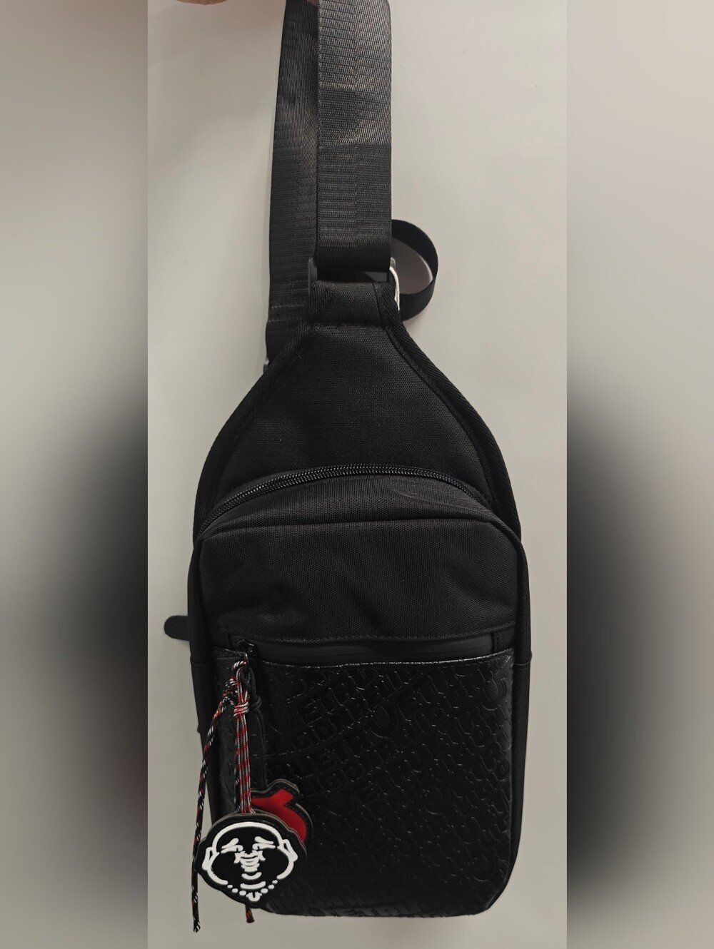 True Religion Wennington Sling Crossbody Black Embossed Logo Buddha Charm NWT